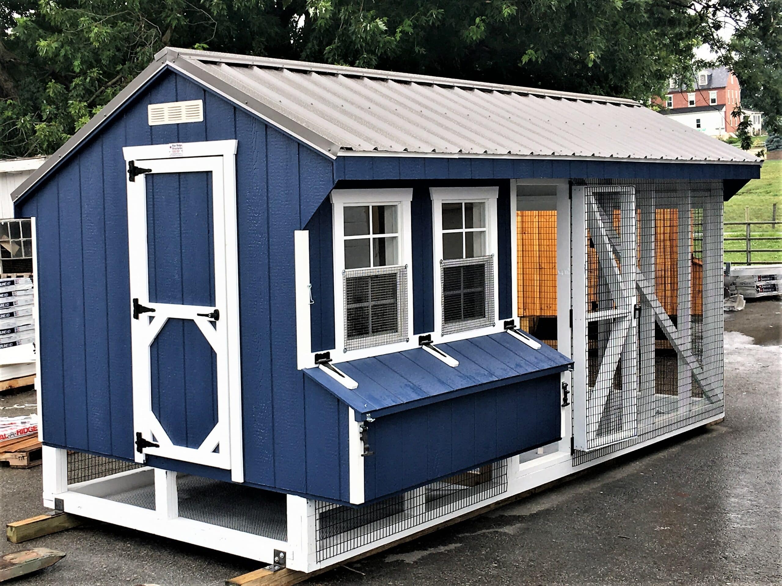 A chicken run with a corrugated metal roof panel installed over one half, providing shade and keeping the ground underneath dry