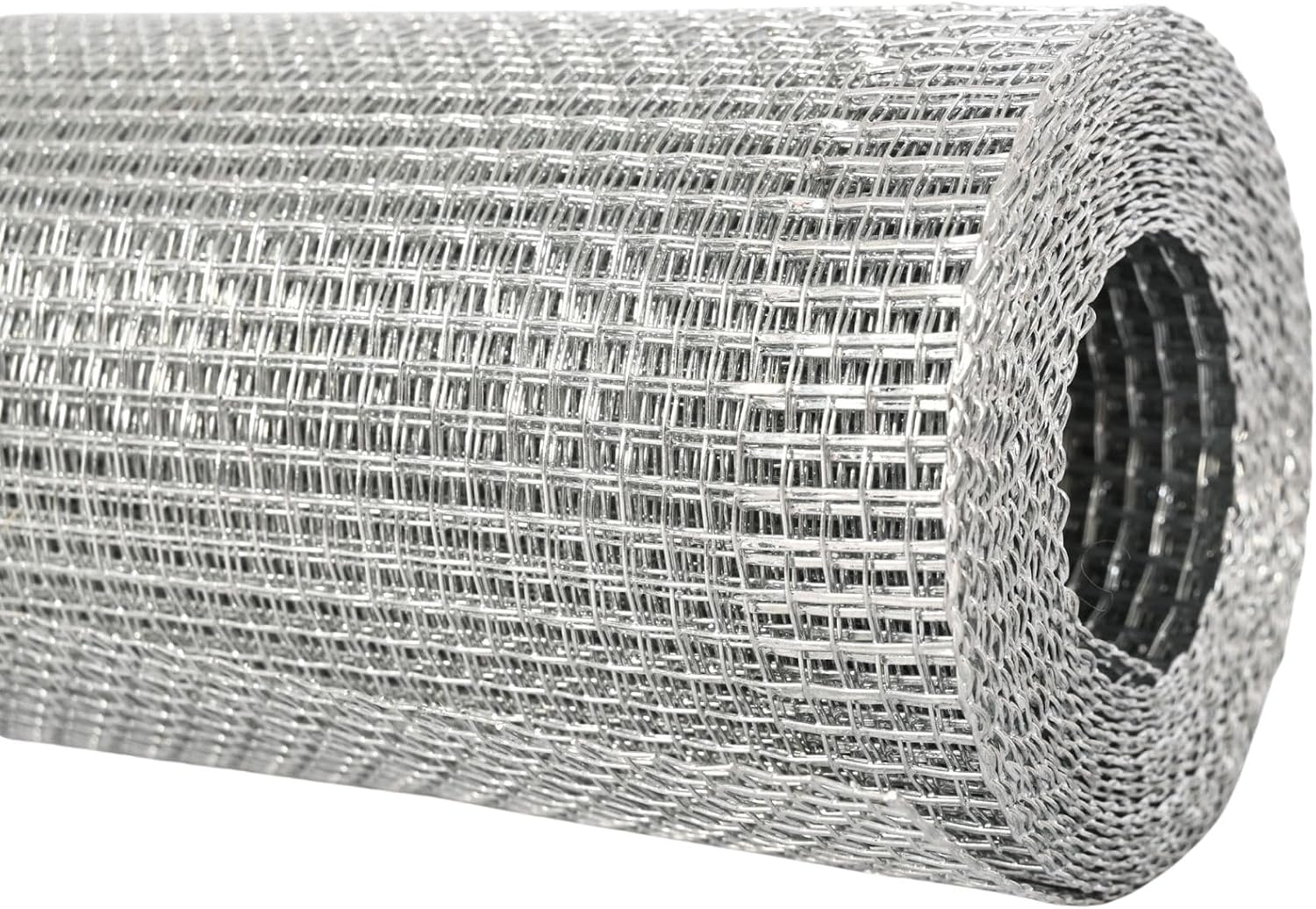 A roll of galvanized hardware cloth leaning against a wooden coop frame on a patio, showing welded square openings