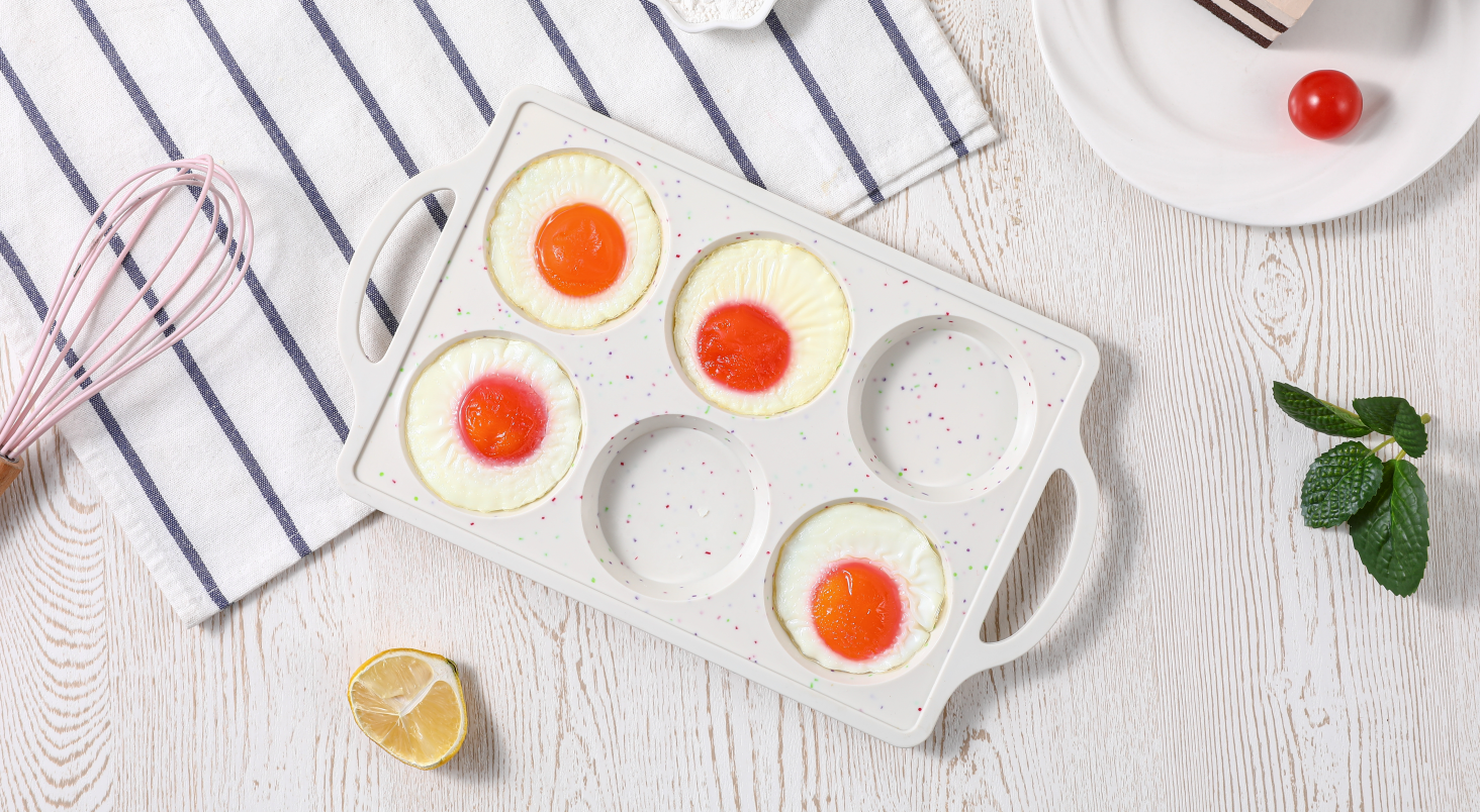 A silicone muffin tray on a counter filled with portions of beaten egg mixture ready to be placed in the freezer
